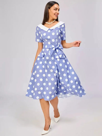 Vintage sky-blue midi dress with white polka dots, contrast collar, and waist tie, perfect for summer weddings and formal events.
