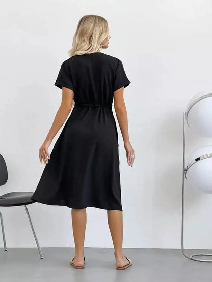 Elegant black midi dress with a tie waist and breezy sleeves, perfect for summer weddings and casual outings.
