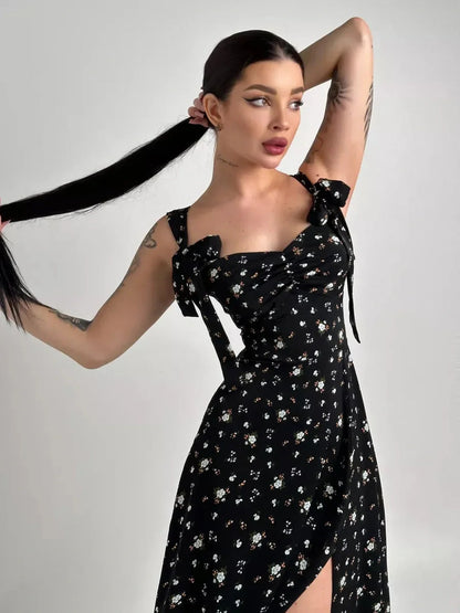 Elegant black floral Elysian Midi Dress with romantic bows, perfect for summer occasions or as a chic wedding guest dress.