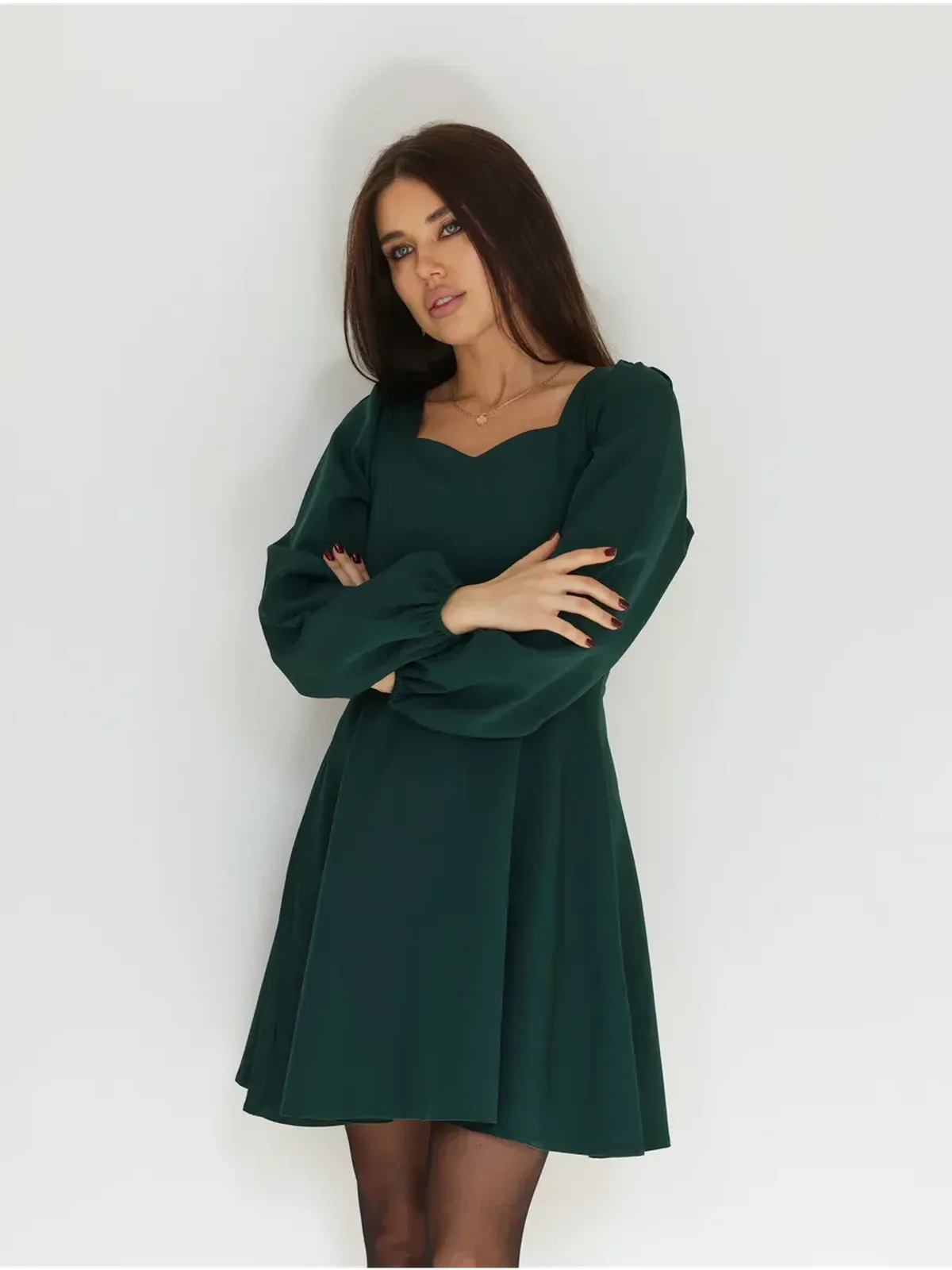 Emerald Grace mini dress featuring a flattering fit-and-flare silhouette and elegant long puff sleeves.