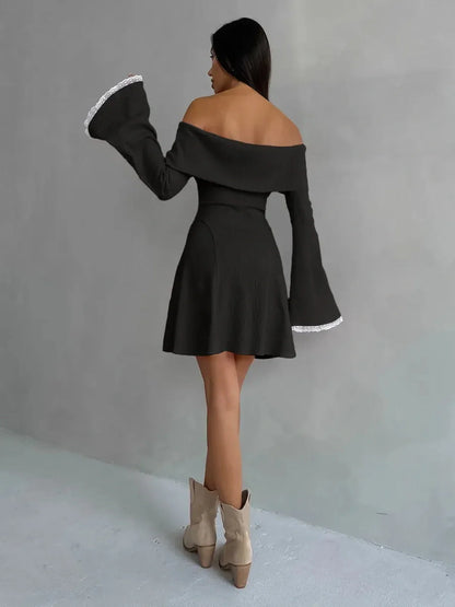 Back view of a woman in a black off-shoulder Velvet Bell Mini Dress with flared sleeves and lace trim.