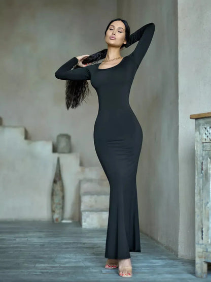 Sculpted Noir Maxi Dress showcasing a sleek black long sleeve silhouette, perfect for formal and evening events.