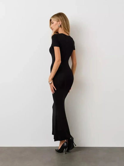 Noir Curve Maxi Dress in black, featuring a sculpted silhouette, short sleeves, and a flared maxi hem, perfect for various occasions.