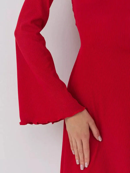 Close-up of a red dress sleeve featuring a bell design and textured fabric, perfect for special occasions and casual wear.