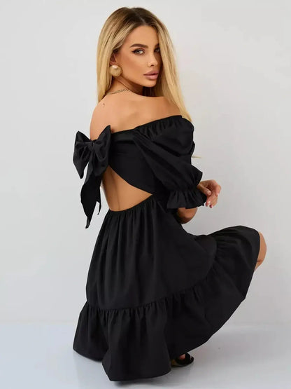 Stylish black mini dress with off-the-shoulder design and bow detail, perfect for summer events and formal occasions.
