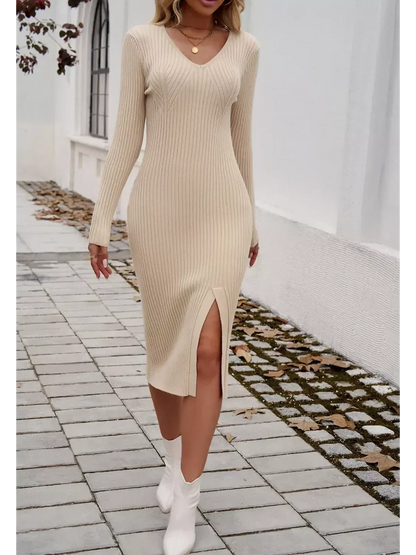 Model wearing a sculpted knit midi dress in light beige with a V-neckline and side slit, perfect for versatile occasions.