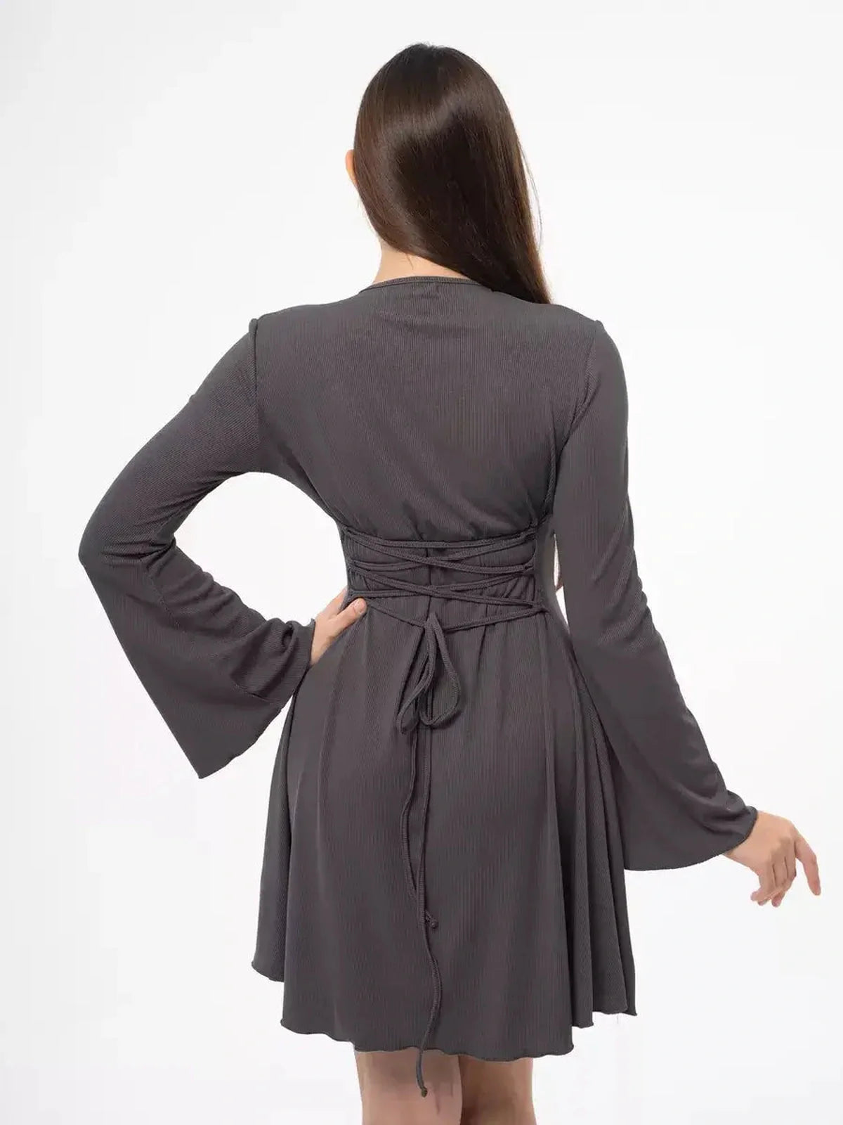 Back view of a graphite tie mini dress featuring flared sleeves and lace-up detail, ideal for formal or wedding events.