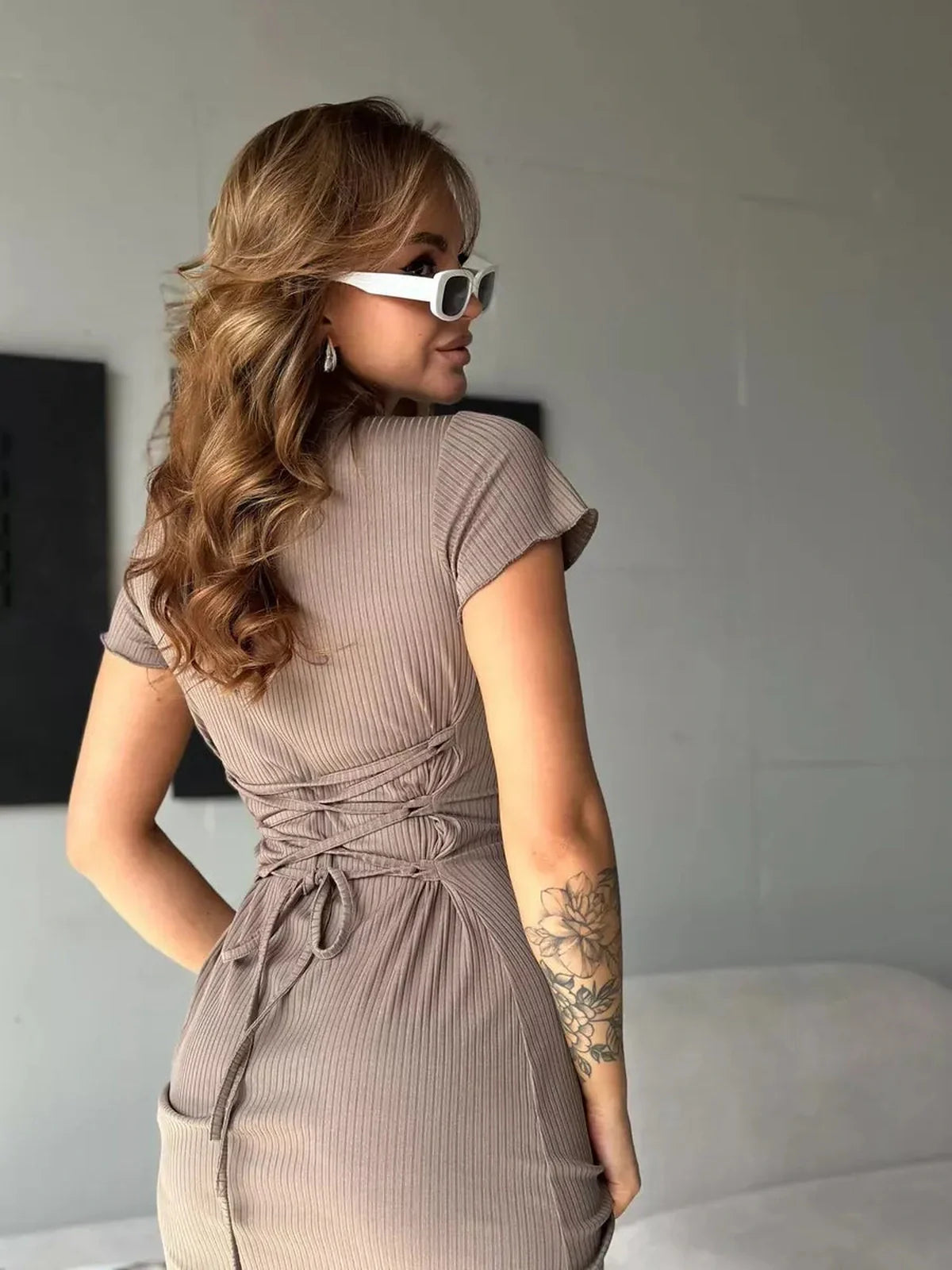 Sleek Contour Midi Dress featuring a lace-up back and ribbed texture, perfect for various occasions. Stylish women's clothing.