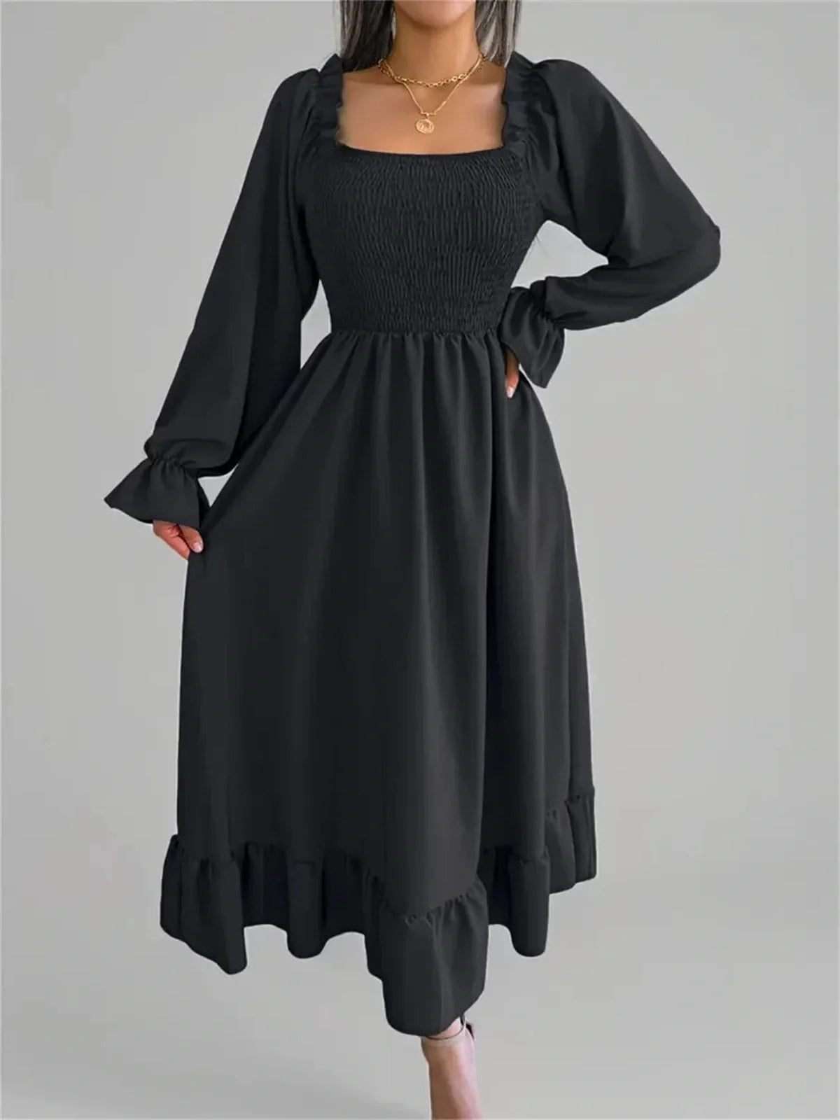 Elegant black Ruffle Grace Midi Dress with smocked bodice and long sleeves, perfect for weddings and special occasions.