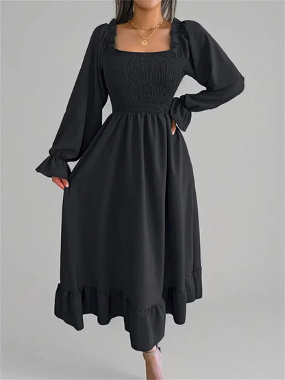 Elegant black Ruffle Grace Midi Dress with smocked bodice and long sleeves, perfect for weddings and special occasions.
