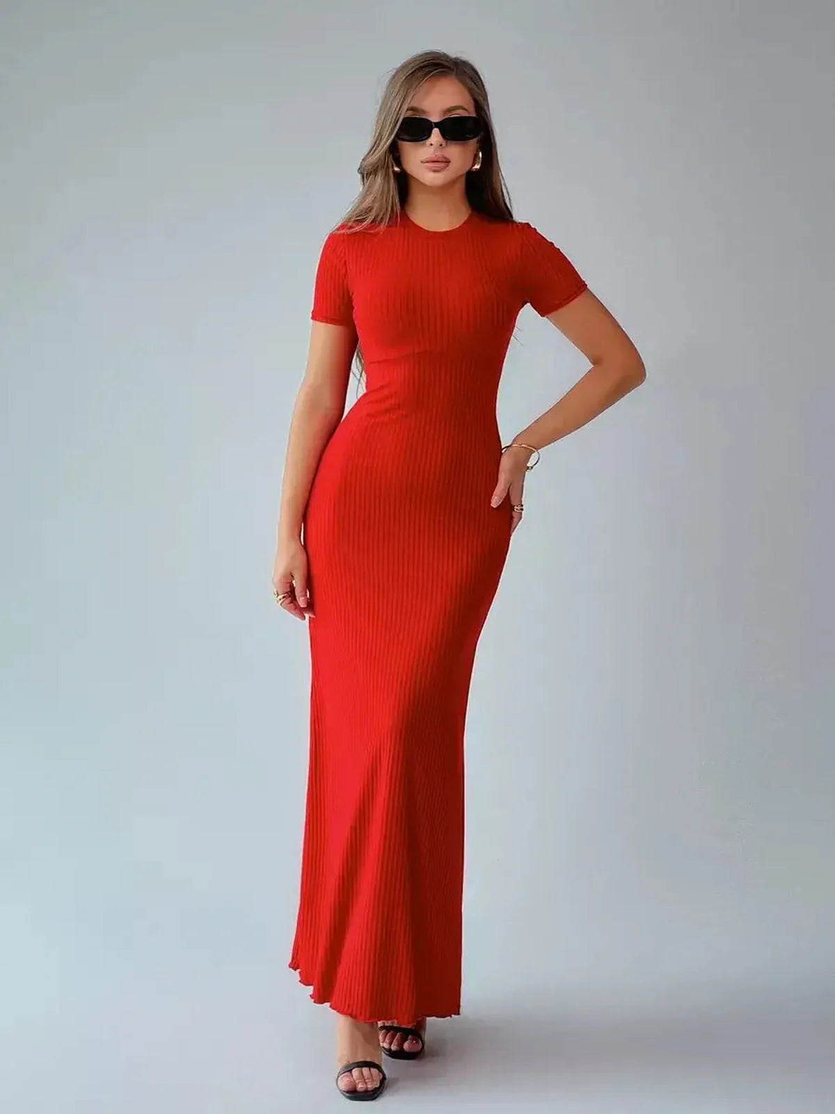 Red ribbed maxi dress on a model, showcasing a fitted silhouette ideal for summer, weddings, or formal occasions.