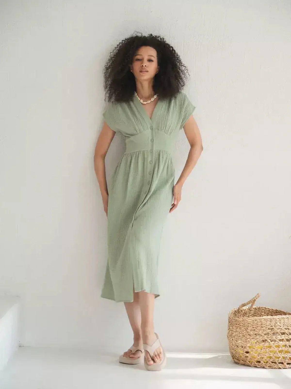 Model wearing a khaki Verdana midi dress with a corset-inspired fit, perfect for summer and casual-chic occasions.