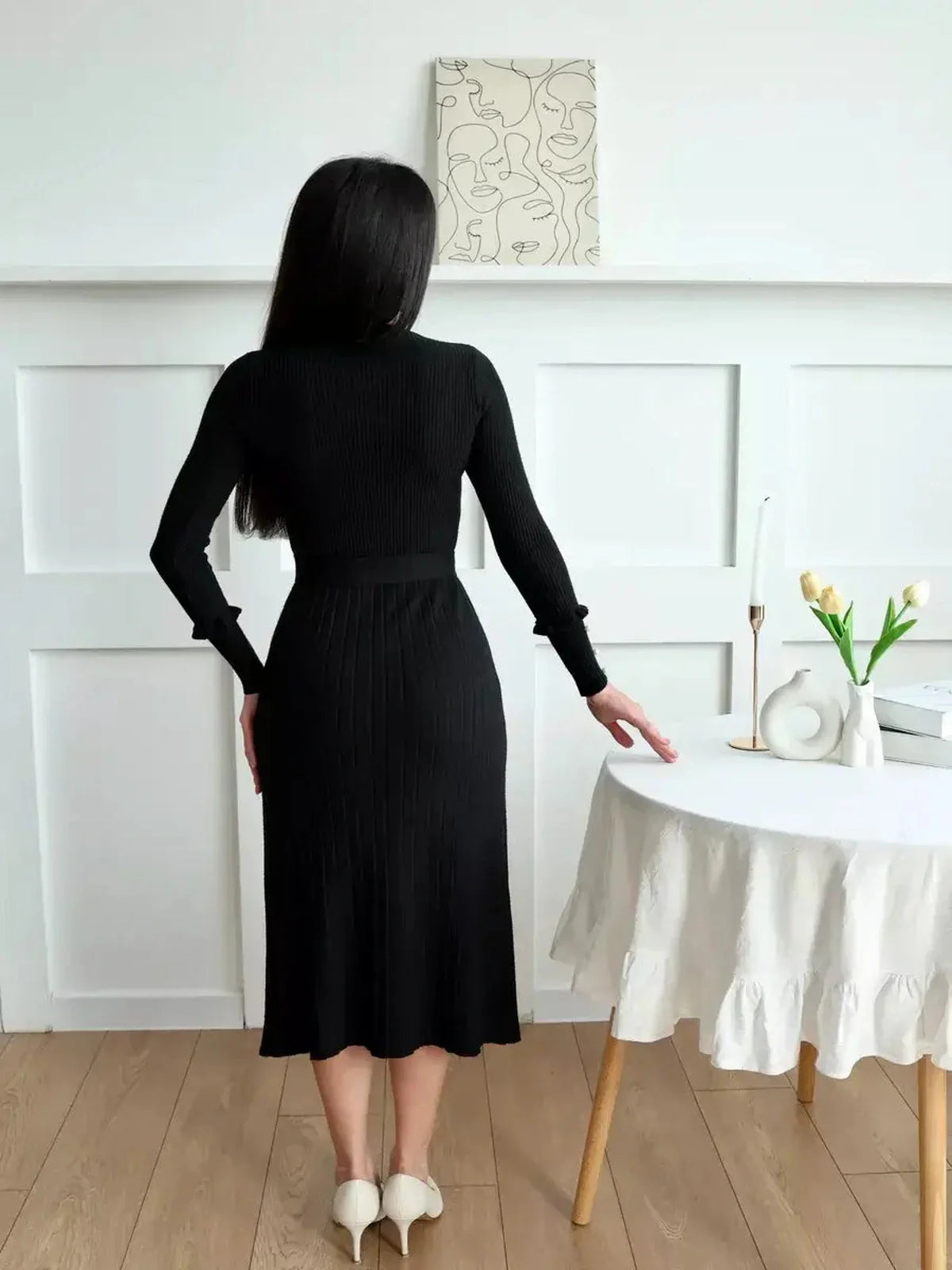 Back view of a woman wearing the Midnight Grace Midi Dress, showcasing its ribbed elegance and flattering silhouette.
