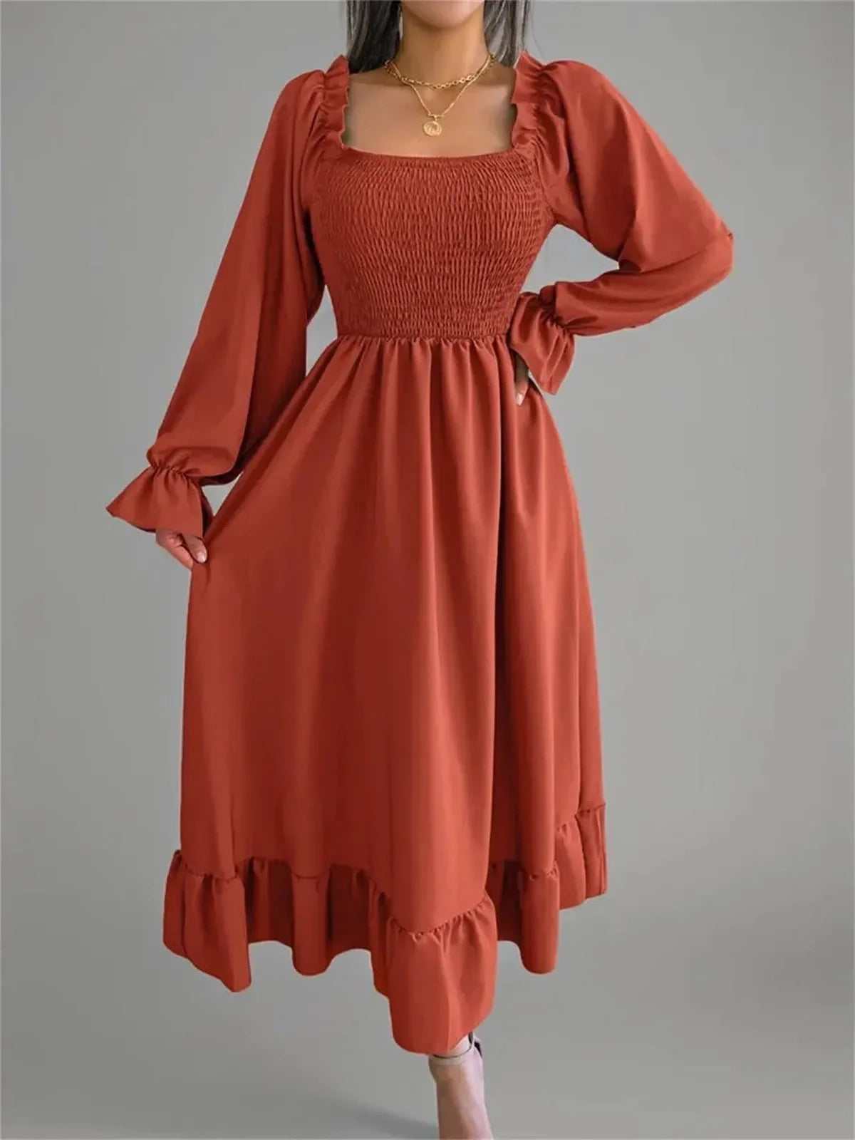 Rust Charm Midi Dress featuring a smocked bodice and flowy skirt, perfect for weddings or casual summer outings.