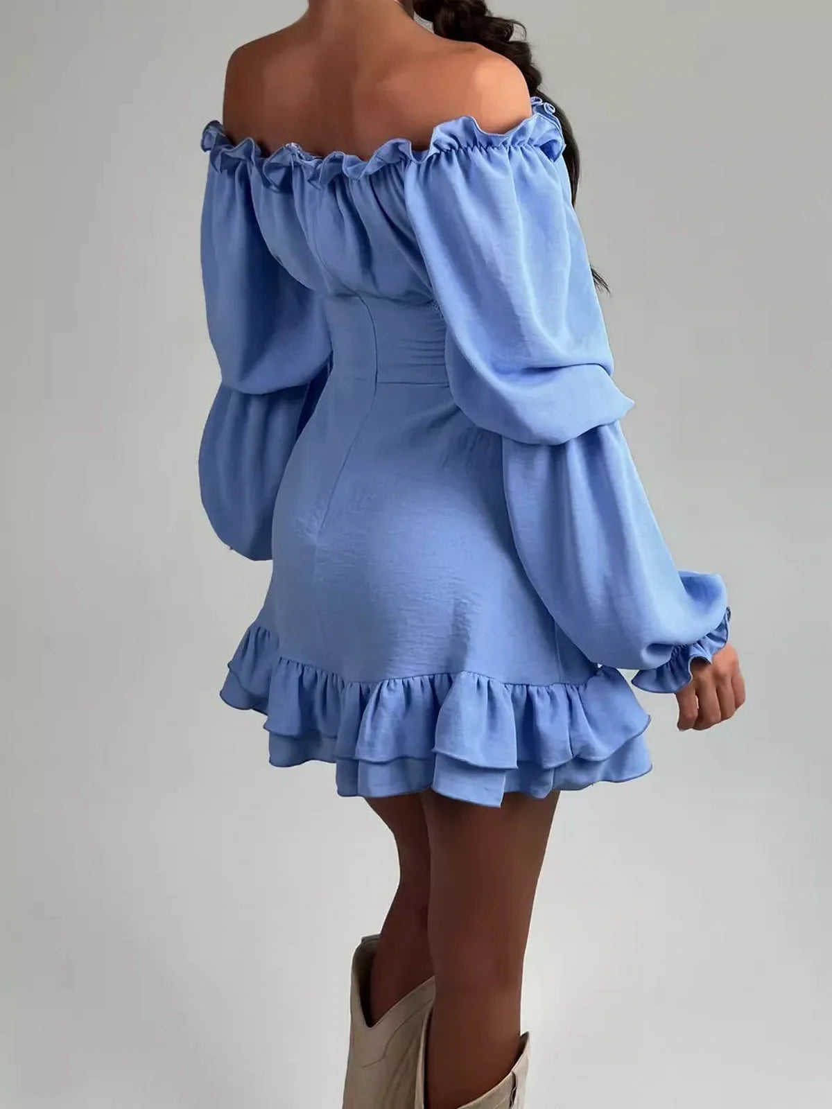 Back view of a sky-blue Boho Frill Mini Dress with off-shoulder design and ruffle hem, perfect for summer and weddings.