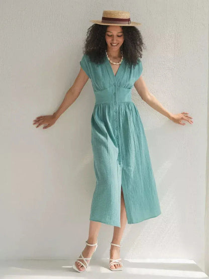 Model wearing a sea-green Veranda Midi Dress with a corset waist and V-neckline, perfect for summer occasions.