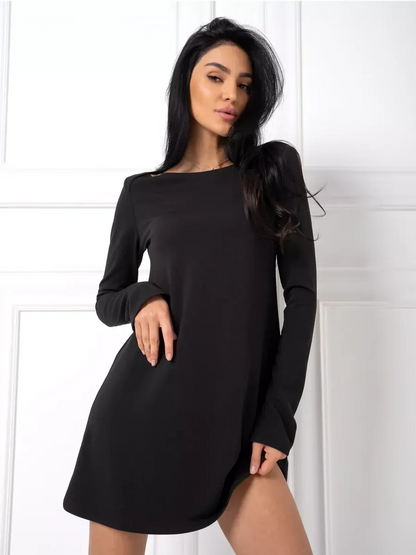Model showcasing a black mini dress with long sleeves and a sleek silhouette, perfect for modern occasions.