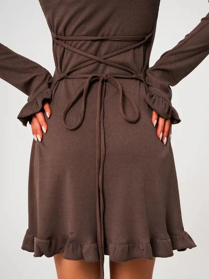 Back view of the Mocha Flare ribbed knit mini dress featuring flared cuffs and a trendy lace-up detail.