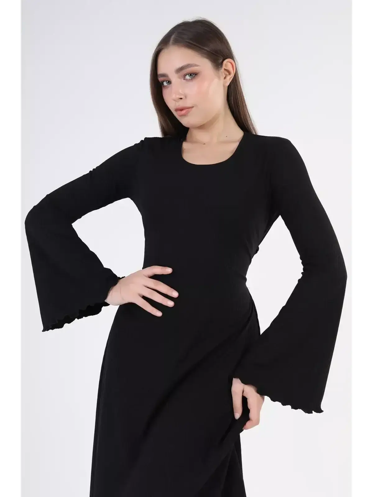 Model wearing the Noir Flare Midi Dress with bell sleeves, showcasing an elegant black silhouette perfect for evening events.