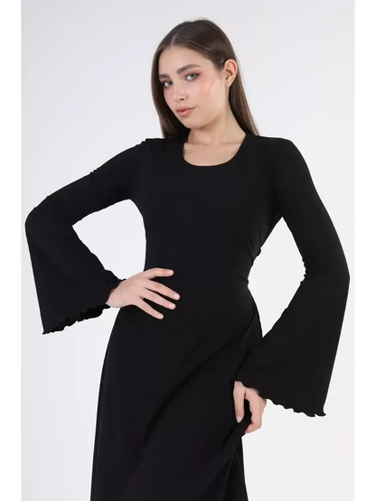 Model wearing the Noir Flare Midi Dress with bell sleeves, showcasing an elegant black silhouette perfect for evening events.