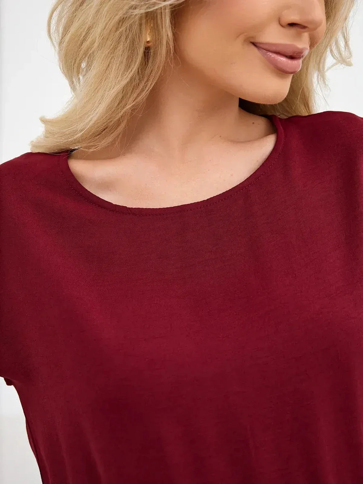 Detail of the Sculpted Ease Maxi Dress in deep burgundy, showcasing its soft fabric and elegant neckline.