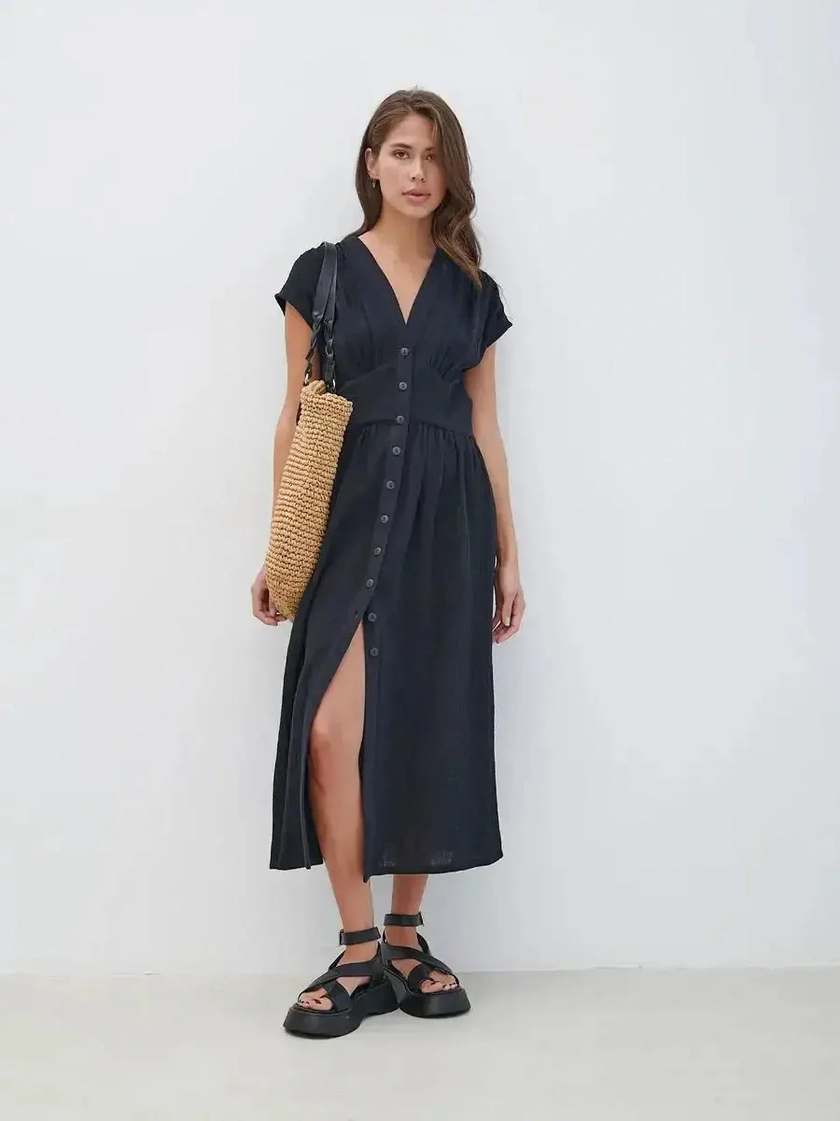 Sable Grace Midi Dress featuring V-neck, button detail, and sculpted waist, styled with a chic bag and sandals.