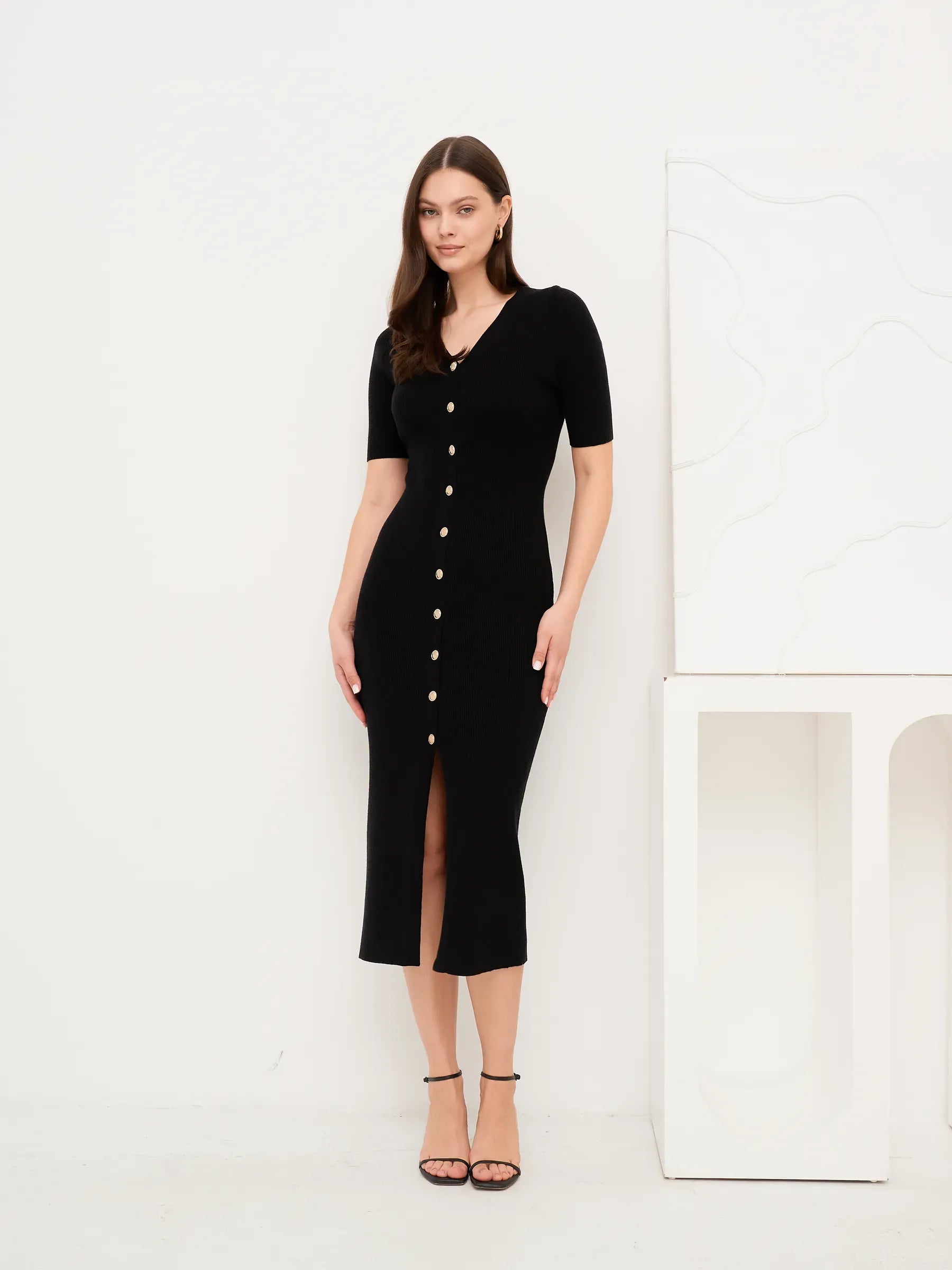Elegant black fitted midi dress with gold buttons, perfect for weddings, parties, or formal occasions.