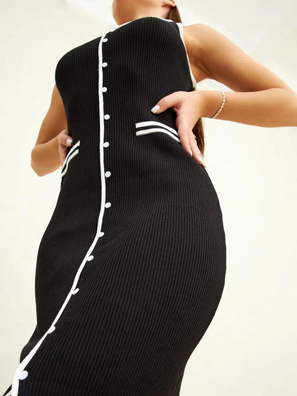 Elegant black midi dress with contrast piping and decorative buttons, perfect for formal occasions and modern wardrobes.