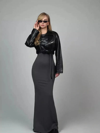 Sculpted Grace Maxi Dress in gray paired with a stylish leather jacket, perfect for evening or formal occasions.