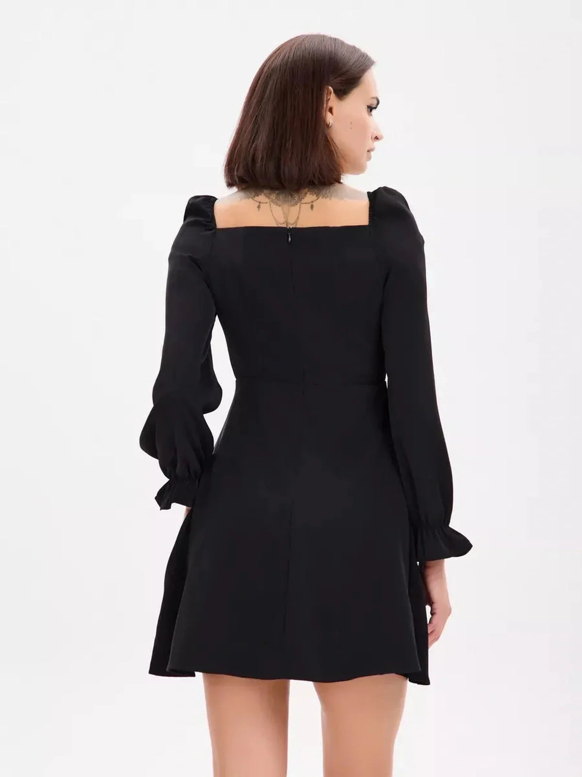 Back view of the Midnight Frame Mini Dress featuring structured sleeves and a flattering square neckline.