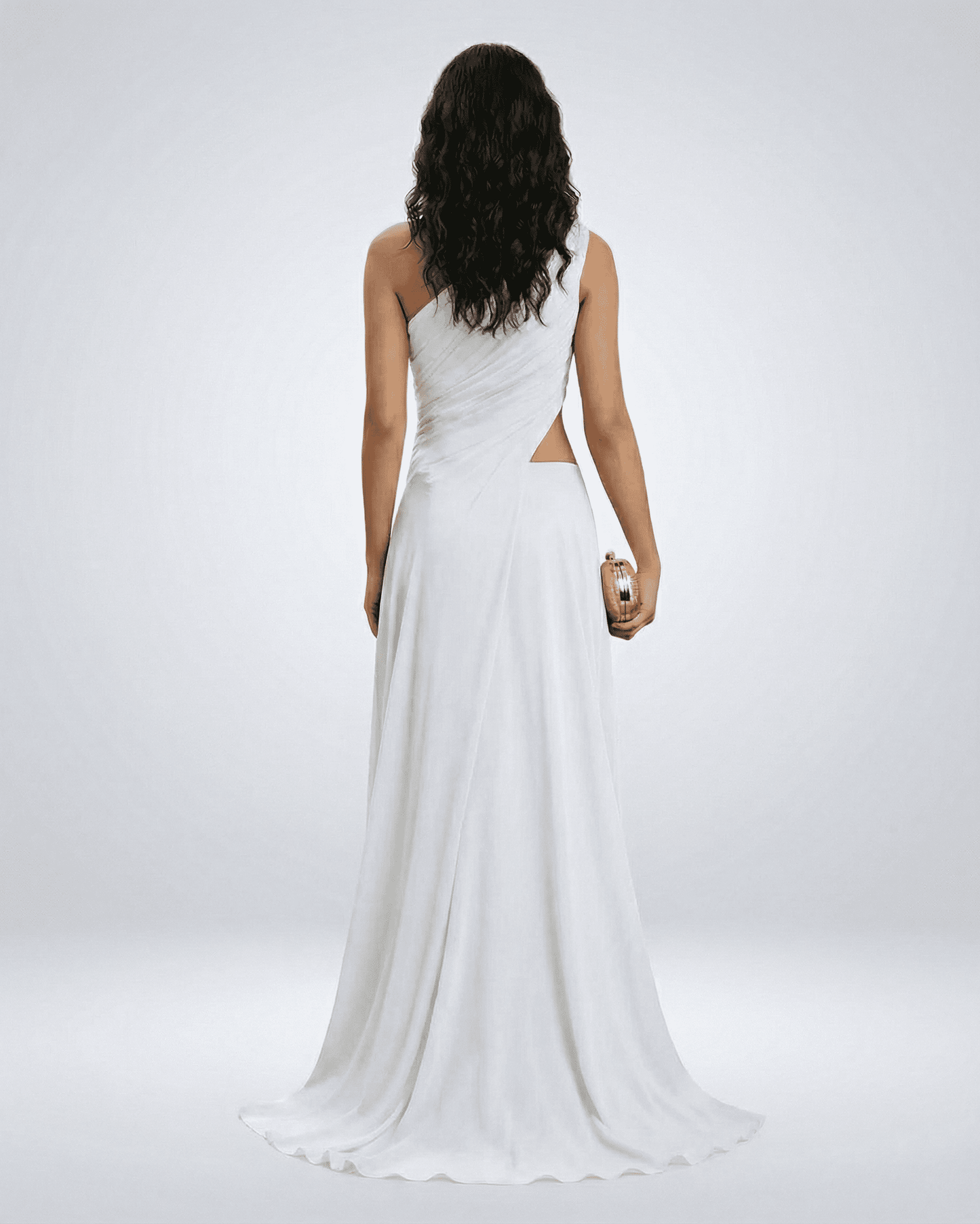 Elegant back view of a woman in the Ivorya Maxi Dress by Slimona, showcasing its one-shoulder design and flowing silhouette.