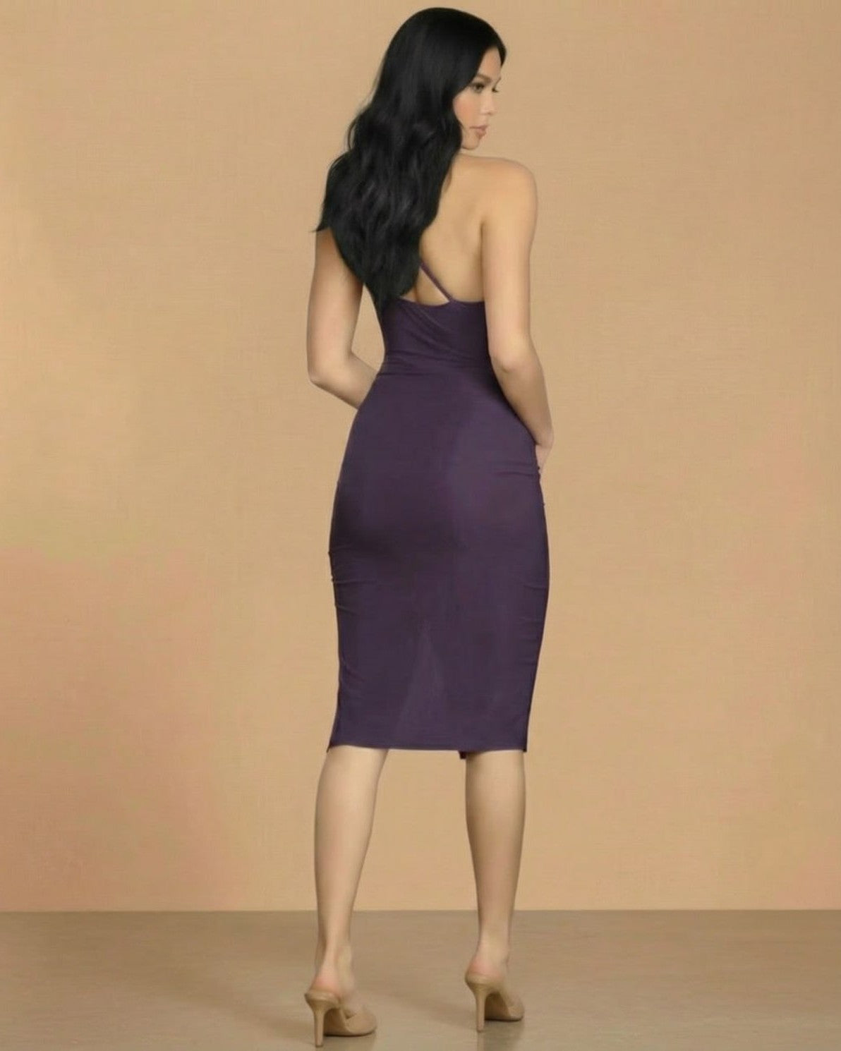 Back view of model wearing Slimona Amethyst Midi Dress, featuring a sleek bodycon fit and elegant cowl neck detail.