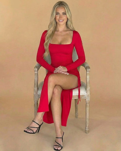 Ravenna Midi Dress - Slimona brand, red bodycon dress with slit and square neck, worn by model seated