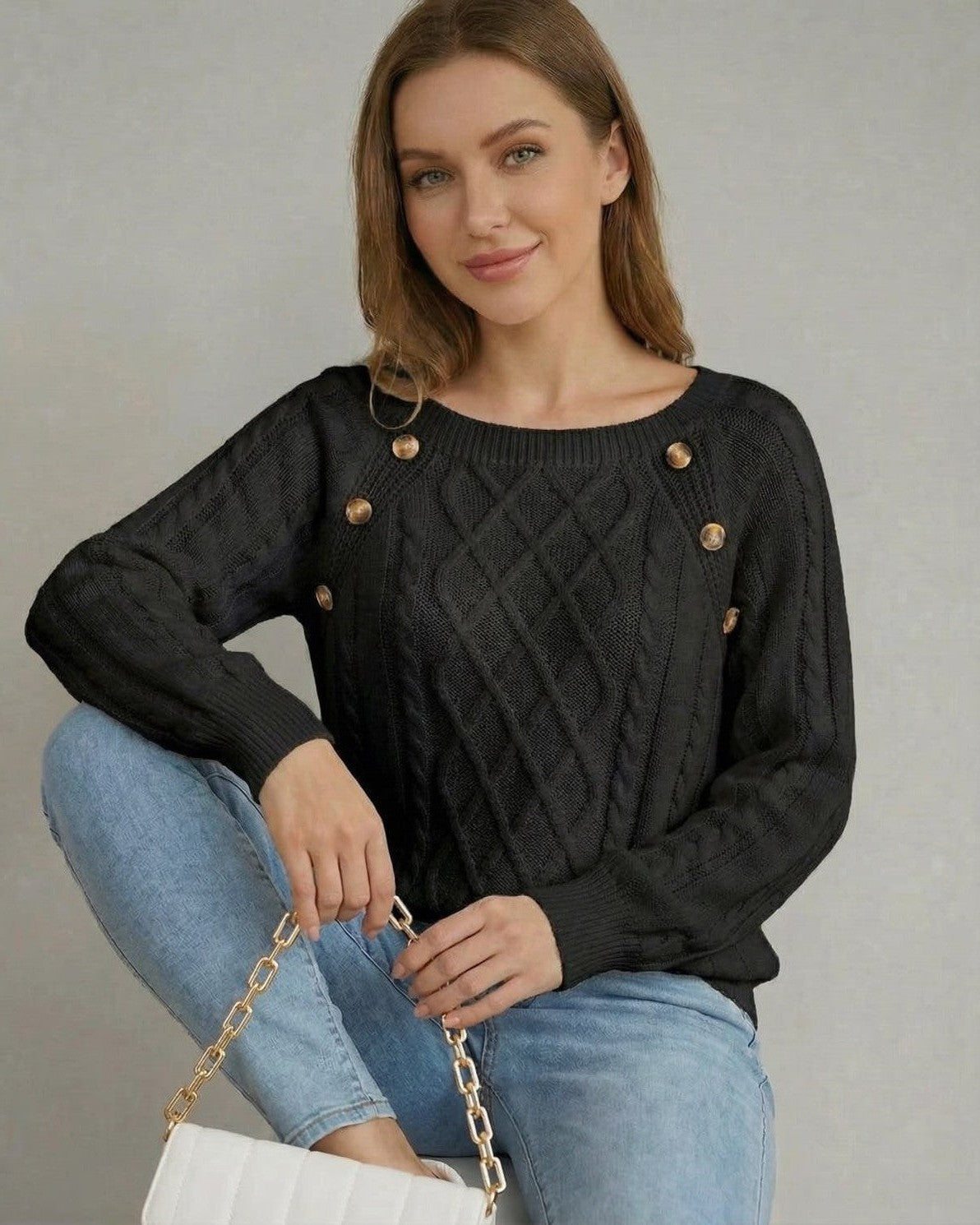 Nyx Pullover by Slimona, a black cable knit sweater with a square collar and decorative buttons.