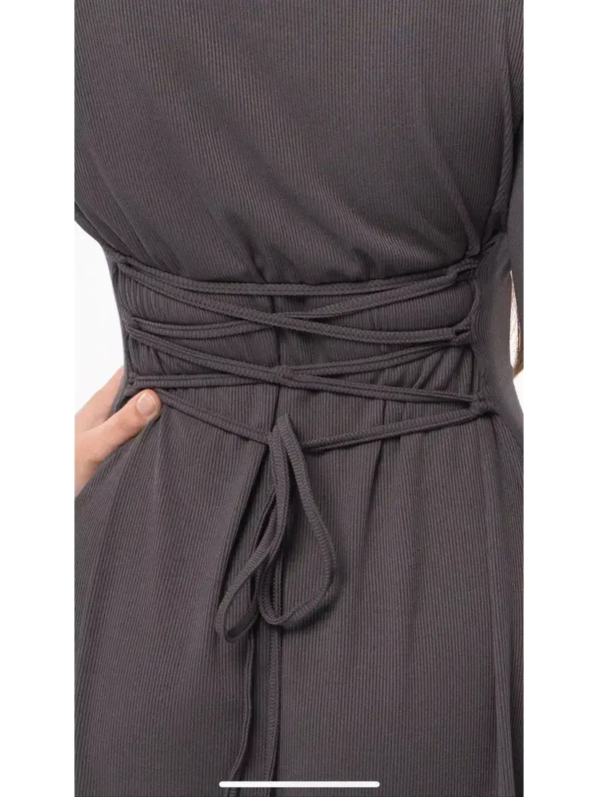 Close-up of the adjustable lace-up detail on the back of a graphite tie mini dress, showcasing its sculpting silhouette.