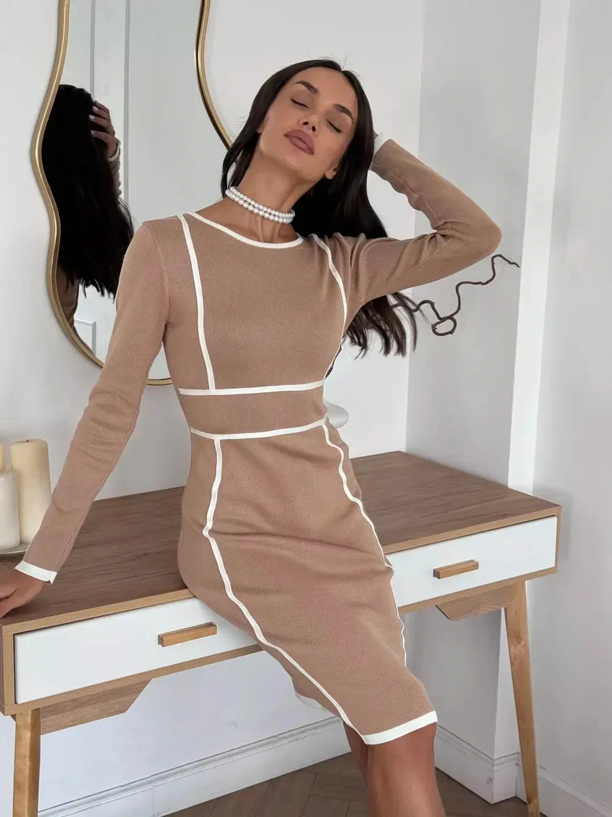 Model showcasing the Outline Midi Dress with bold white trim, perfect for formal events and stylish summer occasions.