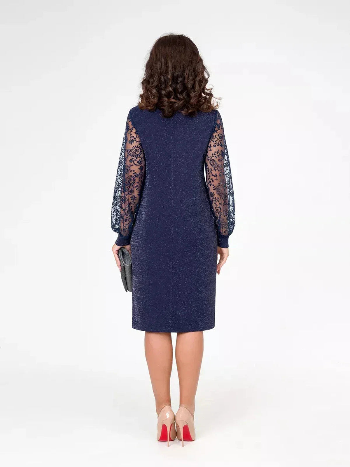 Woman in a navy midi dress with lace sleeves, showcasing elegant style for formal occasions.