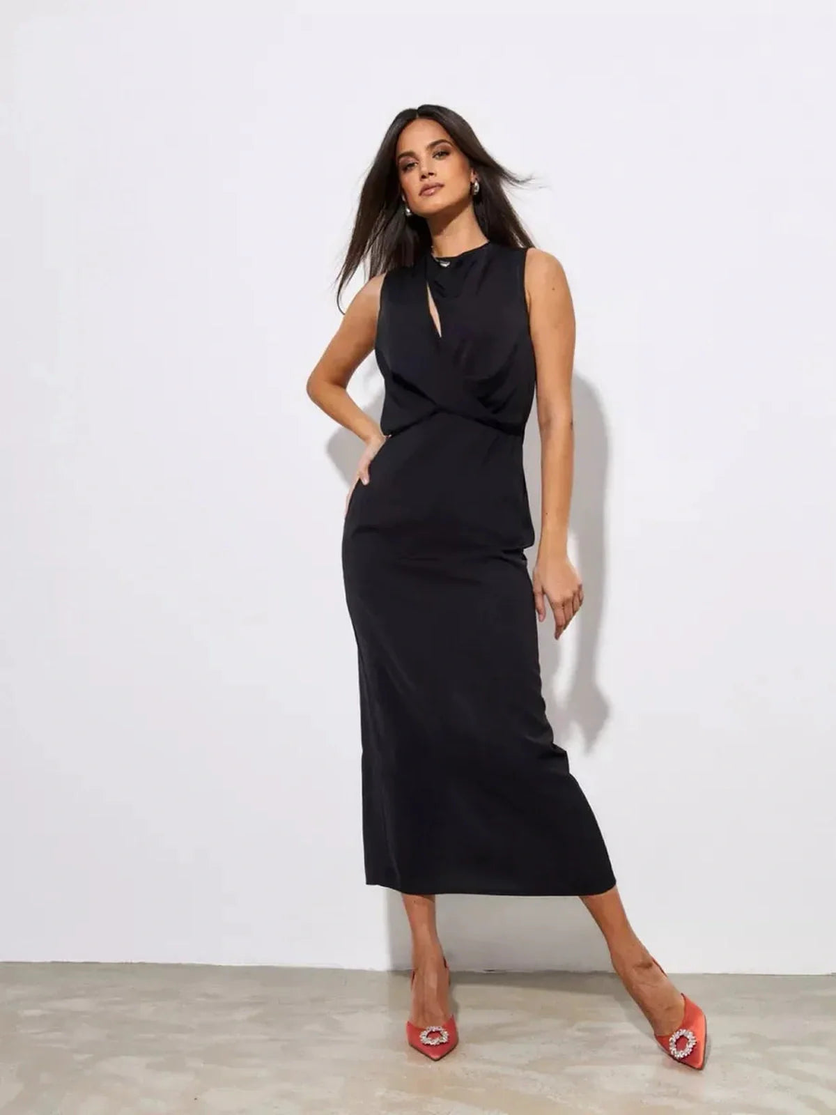 Model showcasing the elegant Noir Drape Maxi Dress in black, perfect for formal events and cocktail occasions.