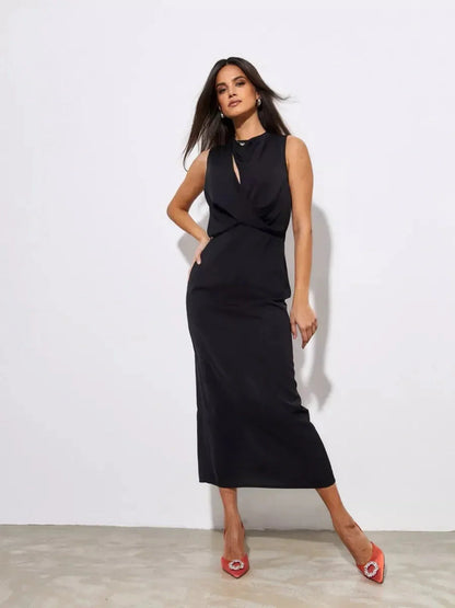 Model showcasing the elegant Noir Drape Maxi Dress in black, perfect for formal events and cocktail occasions.