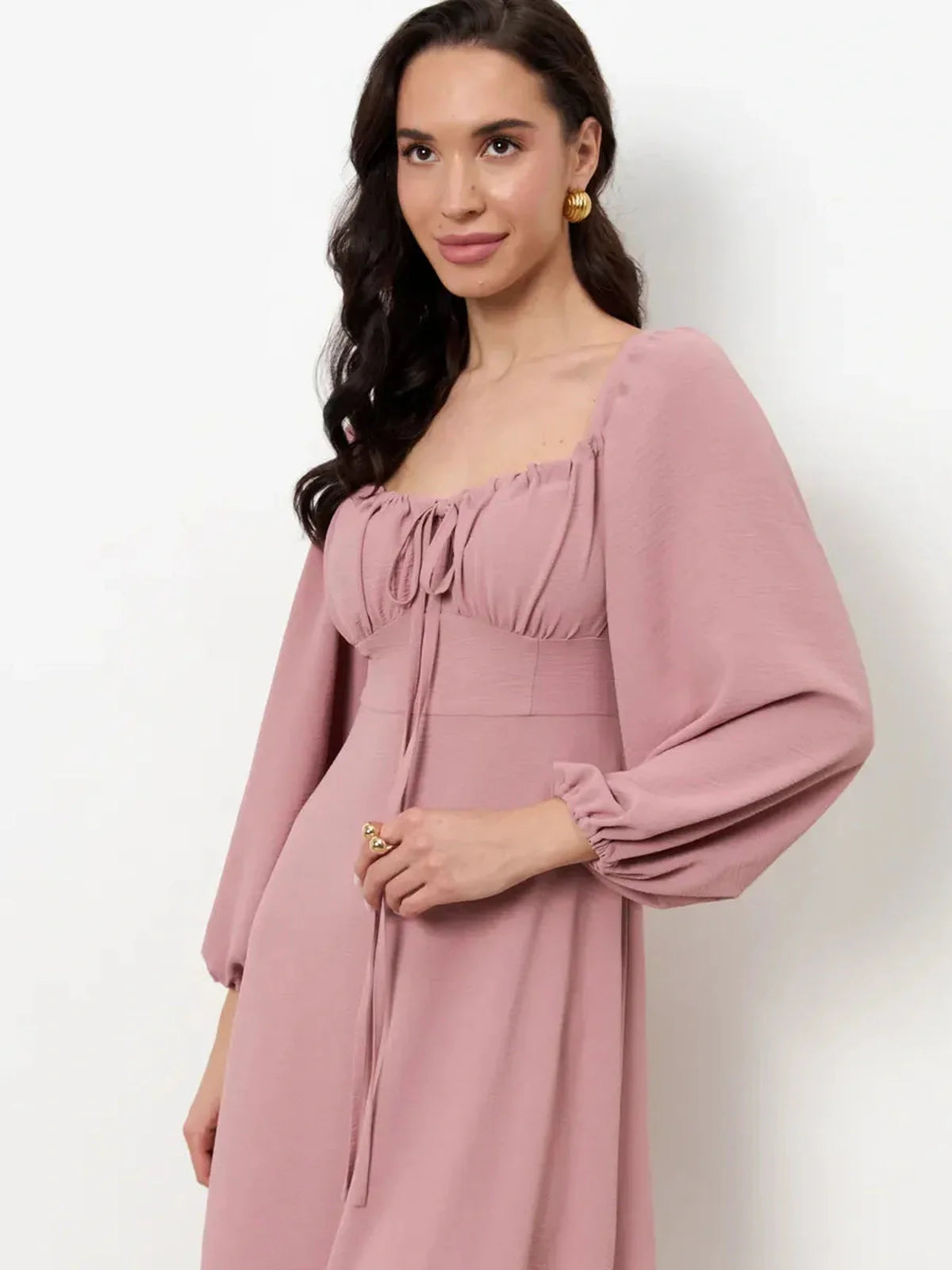Model wearing Blush Charm Midi Dress with square neckline and puff sleeves, showcasing romantic design and feminine elegance.