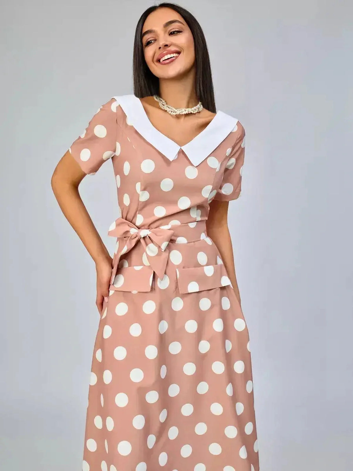 Vintage Muse Midi Dress featuring a polka dot pattern and white collar detail, perfect for summer occasions.