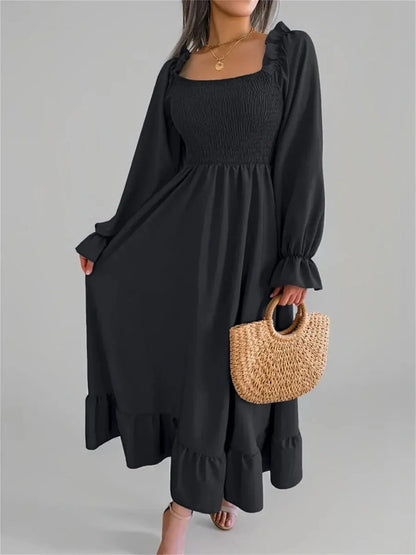 Elegant black ruffle grace midi dress with smocked bodice and long sleeves, perfect for wedding guest and formal occasions.