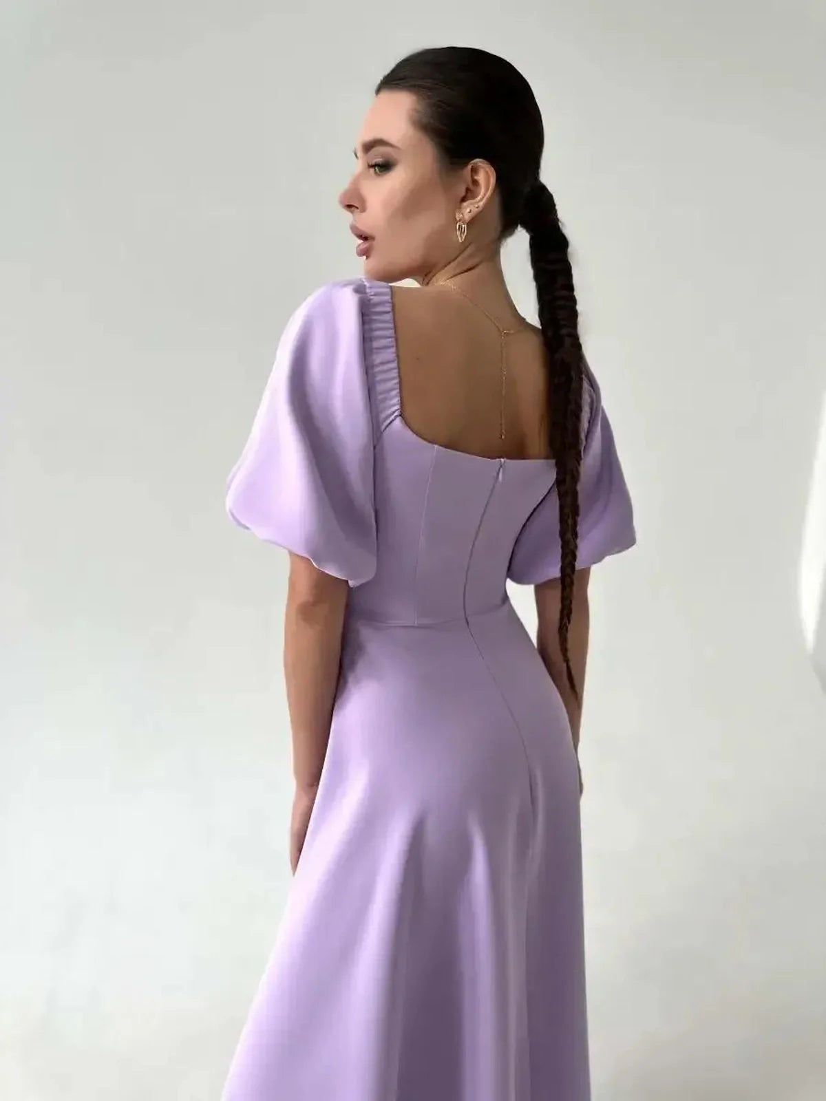 Back view of the Lilac Grace Midi Dress featuring off-shoulder puff sleeves and an elegant silhouette.