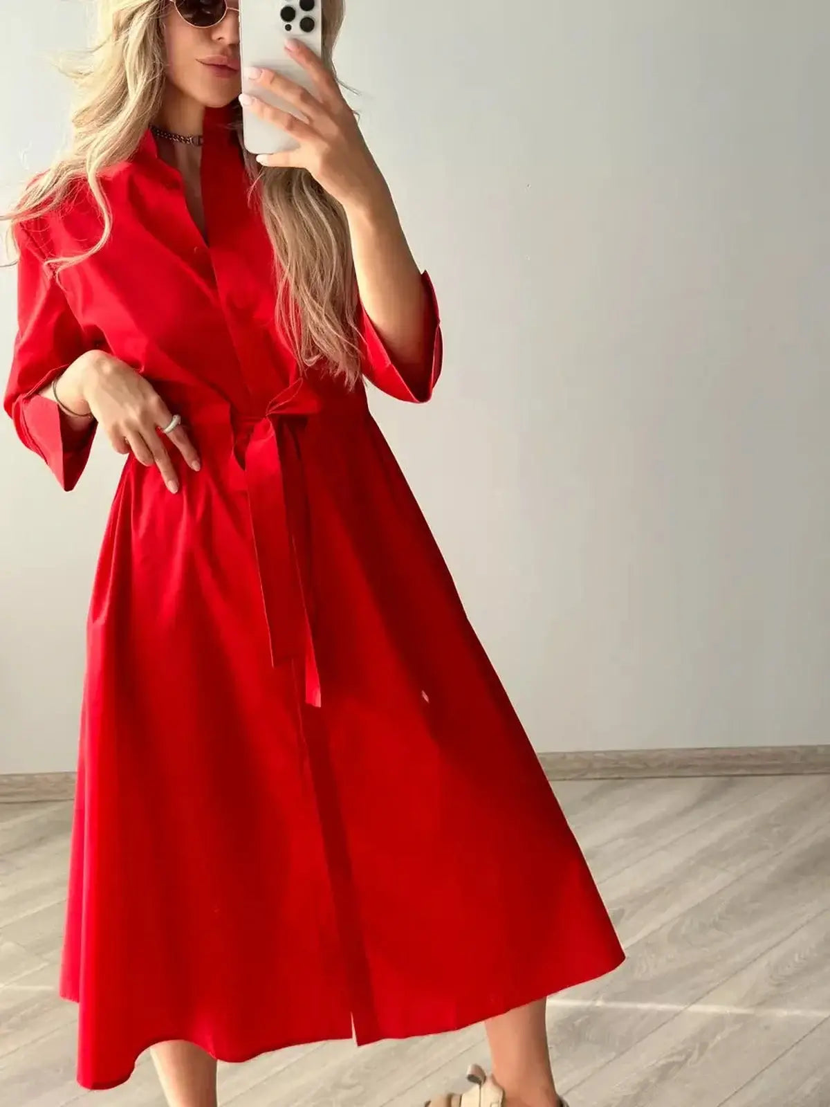 Stylish model showcasing the Crimson Ease Midi Dress in vibrant red, perfect for weddings or everyday elegance.