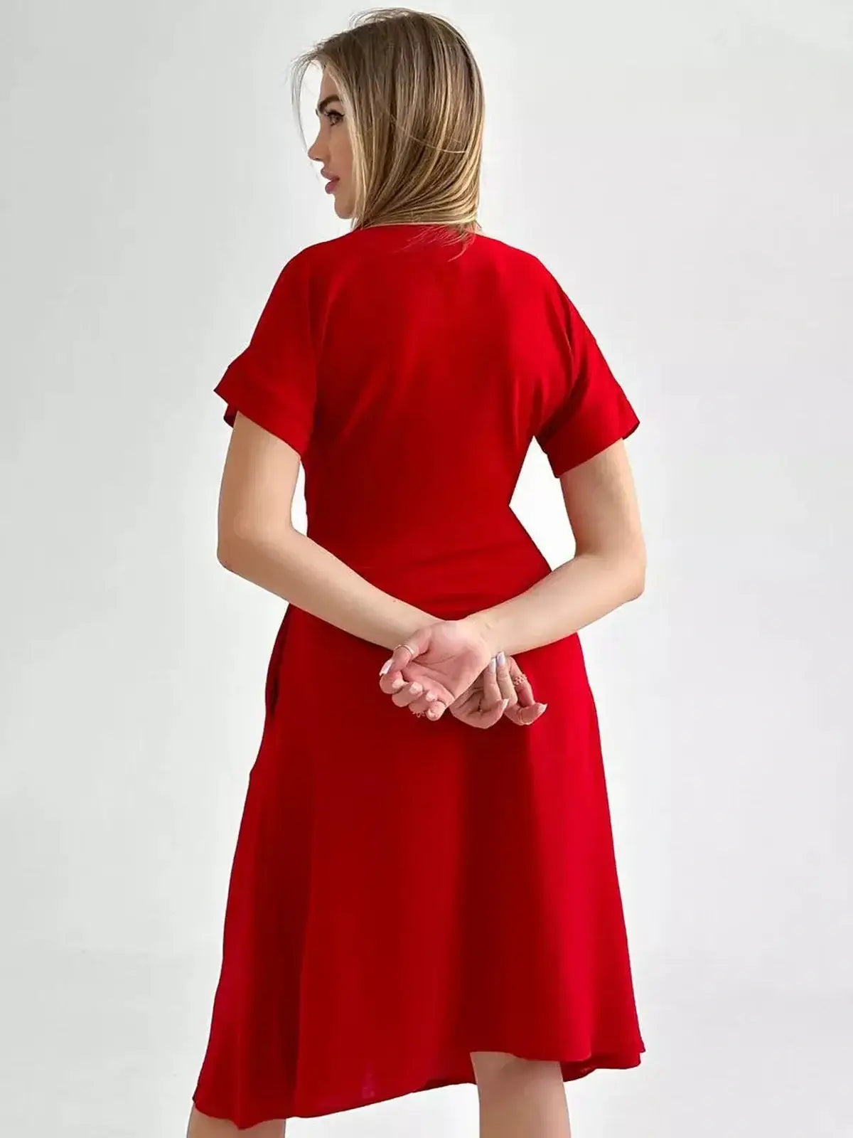Back view of the Crimson Charm Midi Dress in radiant red, featuring short sleeves and a flowing silhouette, perfect for various occasions.