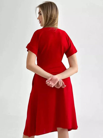Back view of the Crimson Charm Midi Dress in radiant red, featuring short sleeves and a flowing silhouette, perfect for various occasions.