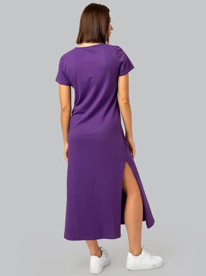 Back view of a model wearing a purple side slit midi dress, showcasing its casual-chic appeal and soft cotton fabric.