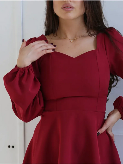 Ruby Flare red dress featuring a sweetheart neckline and elegant puff sleeves, perfect for weddings and special occasions.