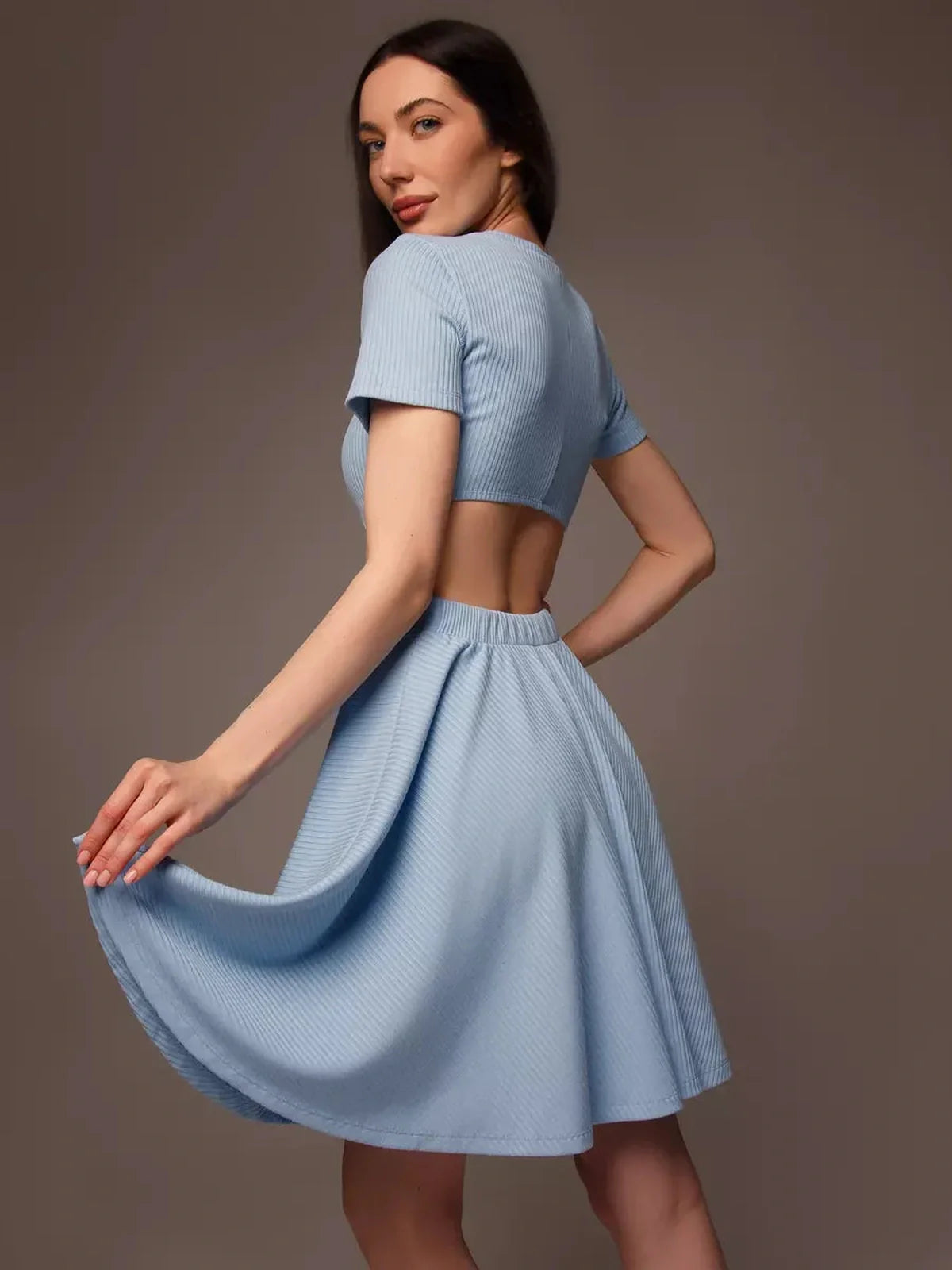 Skyline Bloom mini dress in light blue with a cut-out waist, perfect for summer events and casual outings.