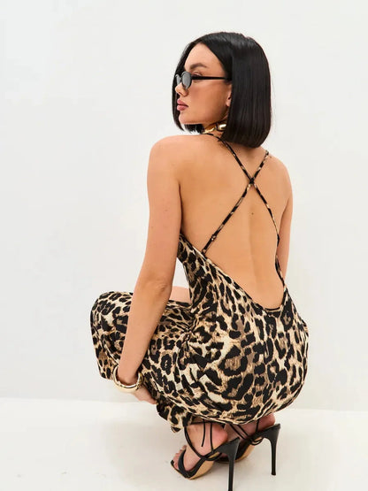 Savage Slip Midi Dress in leopard print with open back and criss-cross straps, perfect for summer parties and events.